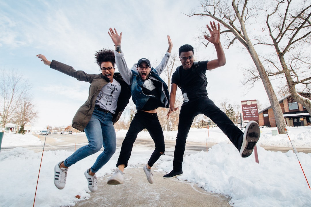 Friends jumping joyfully outside